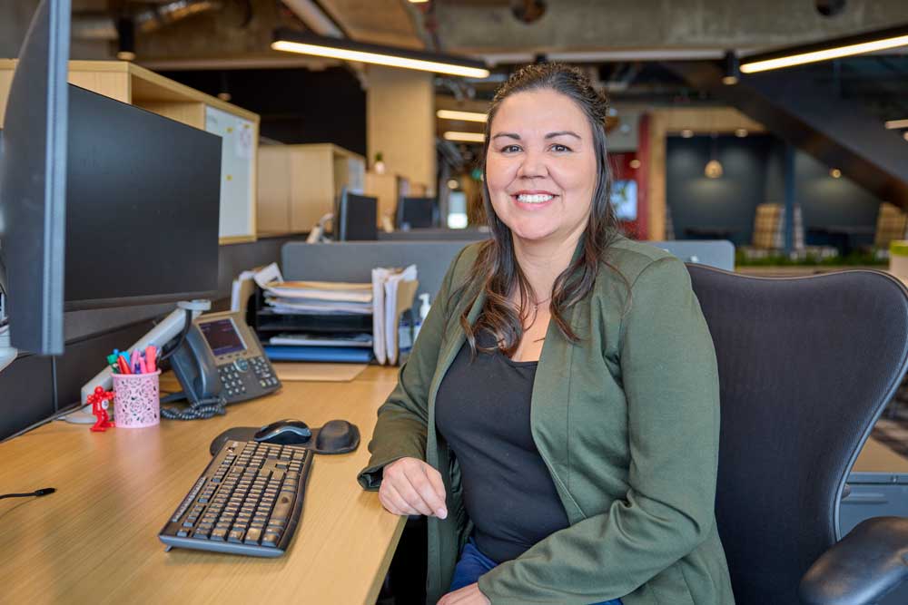 Joanne Zuk sitting at desk in an office